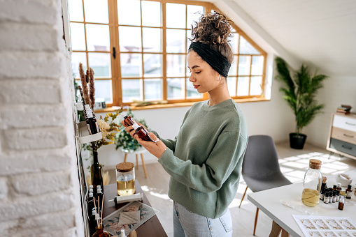 Young beautiful woman working at her small home based workshop