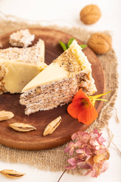 istock Walnut and almond cake on white wooden, side view, selective focus 1492293543