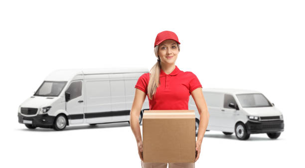 istock Young female courier with transport vans carrying a box 1492299787