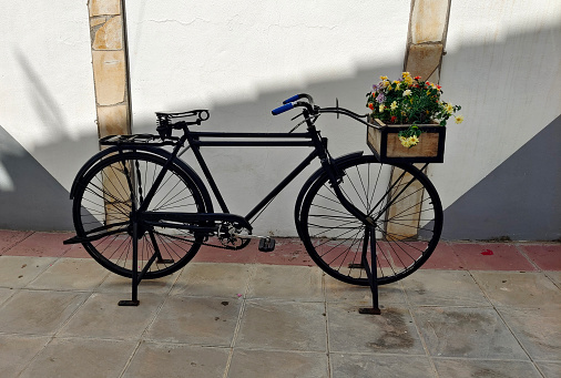 Street of spanish village of el Coronil in Andalusia with bicycle with flowers