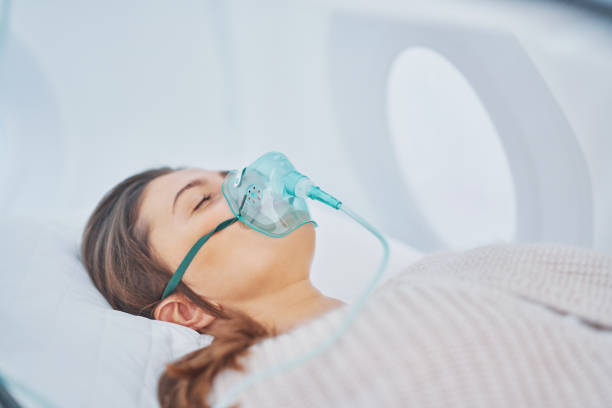 Picture of brunette woman in oxygen cabin stock photo