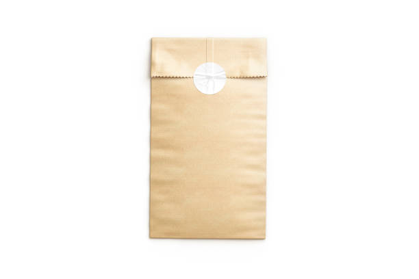 Blank craft rectangle paper bag with sticker mockup, top view, 3d rendering. Empty papery protection pack with tag for mailing mock up, isolated. Clear glue kraft packet for premiss template.