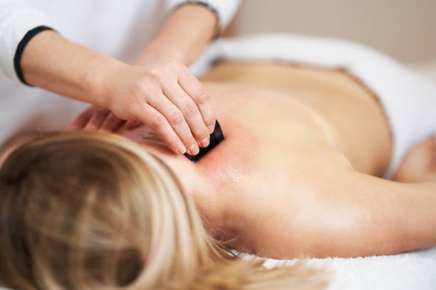 Woman having a gua sha massage in salon