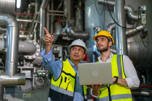 istock Two male engineer working together at factory site control room. 1492305408