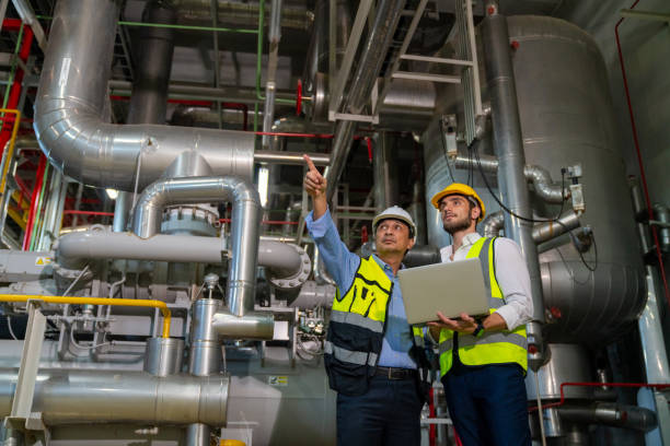 istock Two male engineer working together at factory site control room. 1492305411