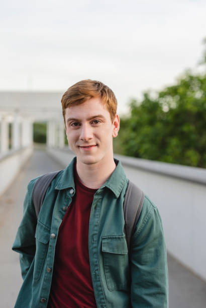 istock young redhead student boy with backpack outside, generation z, influencer 1492305425