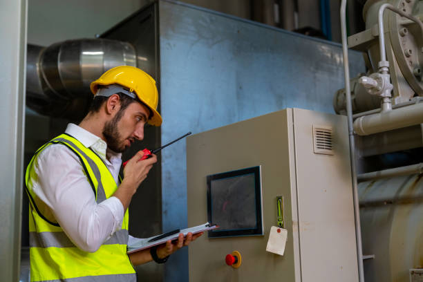 istock Male engineer working and talking on walkie talkie at factory site. 1492305435