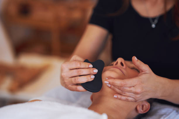 istock Brunette woman having a stone massage on face 1492308594