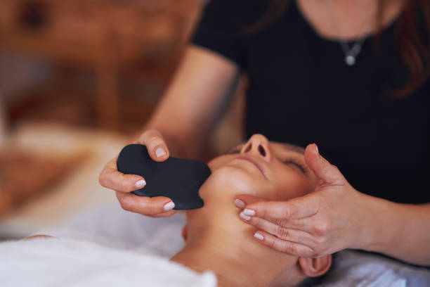 Brunette woman having a stone massage on face
