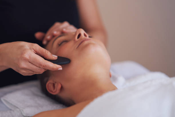 istock Brunette woman having a stone massage on face 1492308901