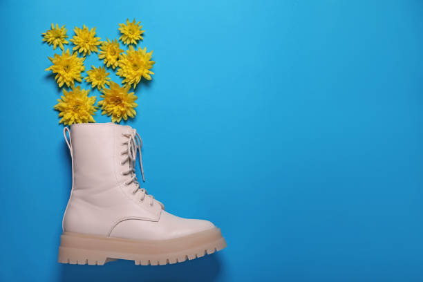 istock Stylish leather shoe with flowers on light blue background, flat lay. Space for text 1492310179