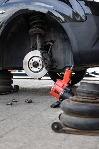 istock Tire change. Brake discs without tire with instruments on the ground 1492310428