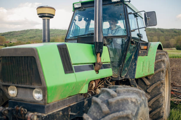 istock Senior farmer driving a tractor on agricultural field 1492311144
