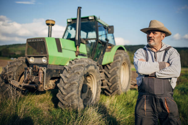 Farmer with tractor working on the agricultural field