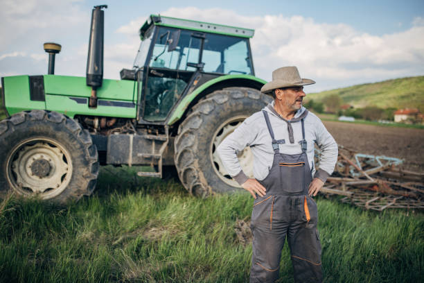 istock Farmer with tractor working on the agricultural field 1492311842