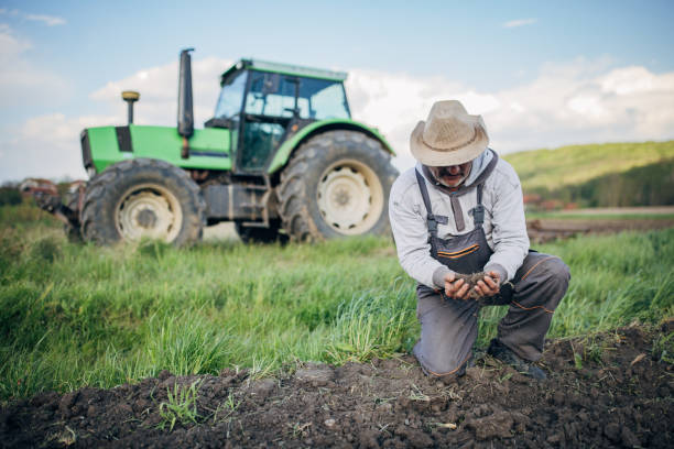 istock Farmer with tractor working on the agricultural field 1492311978