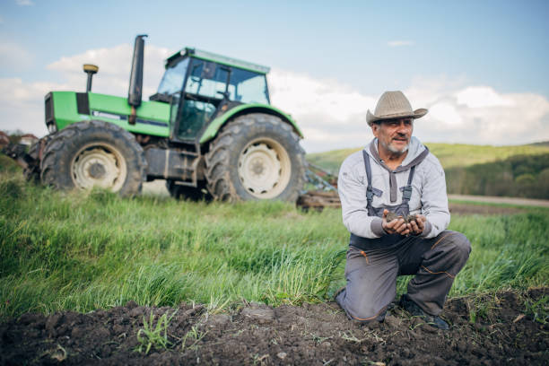 istock Farmer with tractor working on the agricultural field 1492312517