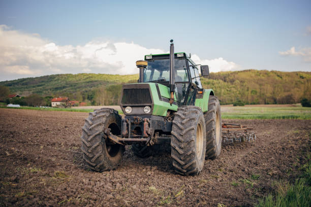 istock Senior farmer driving a tractor on agricultural field 1492312872