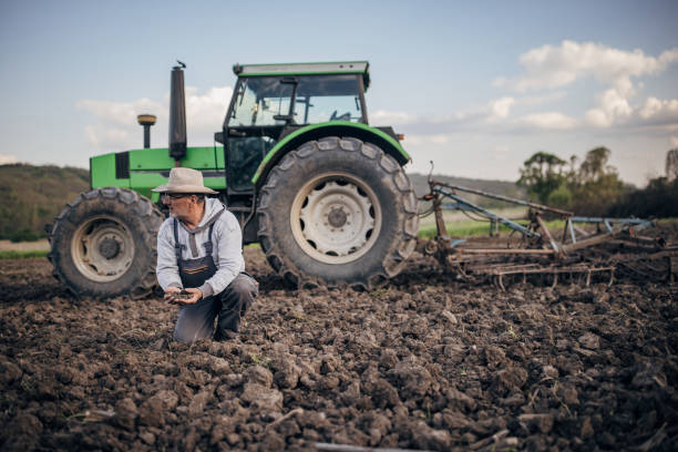 istock Farmer with tractor working on the agricultural field 1492313091
