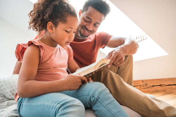 istock Mixed Race Daughter Reading To Her Black Father 1492313127