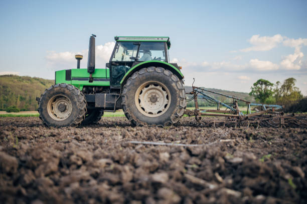istock Senior farmer driving a tractor on agricultural field 1492313397