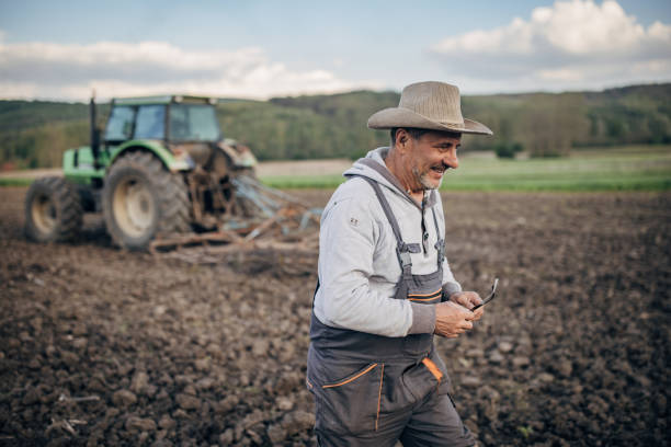 istock Farmer with tractor working on the agricultural field 1492313422