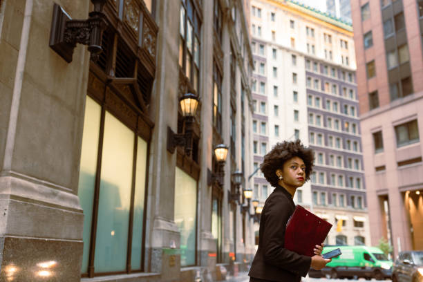 istock On the Go: Ambitious Businesswoman Balancing Taxi Arrival, Document Folder, and Email 1492315171
