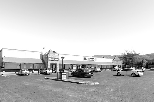 Prince Alfred Hamlet, South Africa - Sep 9, 2022: A supermarket in Prince Alfreds Hamlet near Ceres in the Western Cape Province. Vehicles are visible. Monochrome