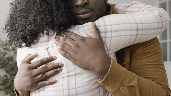 Caring black husband supports his upset wife as they work through problems in their marriage