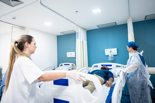 Nurses moving the patient in the hospital