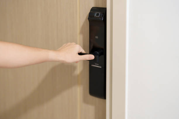 istock Hand using smart digital door lock while open or close the door at home or apartment. NFC Technology, Fingerprint scan, keycard, PIN number, smartphone, electrical and contactless lifestyle concepts 1492326811