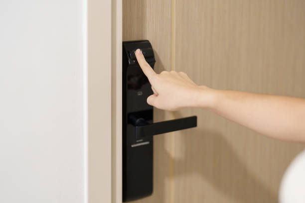 istock Hand using fingerprint scan for smart digital door lock while open or close the door at home or apartment. NFC Technology, keycard, PIN number, smartphone and contactless lifestyle concepts 1492326812
