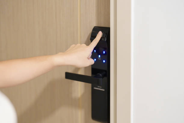 istock Hand using fingerprint scan for smart digital door lock while open or close the door at home or apartment. NFC Technology, keycard, PIN number, smartphone and contactless lifestyle concepts 1492326817