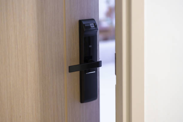 istock smart digital door lock while open or close the door at home or apartment. NFC Technology, Fingerprint scan, keycard, PIN number, smartphone, electrical and contactless lifestyle concepts 1492326840