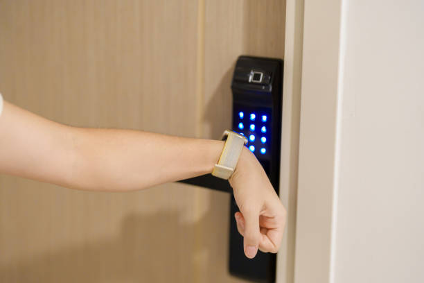 istock Hand using smartwatch for open digital door lock at home or apartment. NFC Technology, Fingerprint scan, keycard, PIN number, smartphone, electrical and contactless lifestyle concepts 1492326884