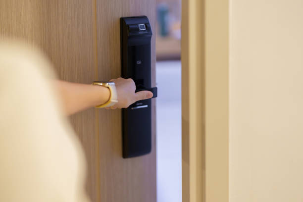 istock Hand using smart digital door lock while open or close the door at home or apartment. NFC Technology, Fingerprint scan, keycard, PIN number, smartphone, electrical and contactless lifestyle concepts 1492326926
