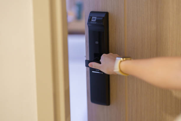 istock Hand using smart digital door lock while open or close the door at home or apartment. NFC Technology, Fingerprint scan, keycard, PIN number, smartphone, electrical and contactless lifestyle concepts 1492326931