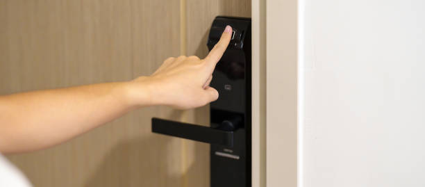 istock Hand using fingerprint scan for smart digital door lock while open or close the door at home or apartment. NFC Technology, keycard, PIN number, smartphone and contactless lifestyle concepts 1492326989