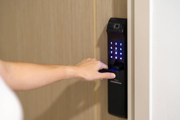 istock Hand using smart digital door lock while open or close the door at home or apartment. NFC Technology, Fingerprint scan, keycard, PIN number, smartphone, electrical and contactless lifestyle concepts 1492327021