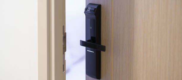 istock smart digital door lock while open or close the door at home or apartment. NFC Technology, Fingerprint scan, keycard, PIN number, smartphone, electrical and contactless lifestyle concepts 1492327027