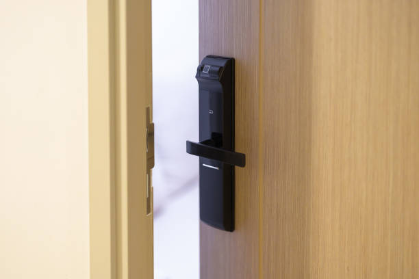 istock smart digital door lock while open or close the door at home or apartment. NFC Technology, Fingerprint scan, keycard, PIN number, smartphone, electrical and contactless lifestyle concepts 1492327033