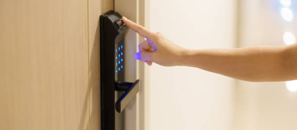 istock Hand using fingerprint scan for smart digital door lock while open or close the door at home or apartment. NFC Technology, keycard, PIN number, smartphone and contactless lifestyle concepts 1492327085