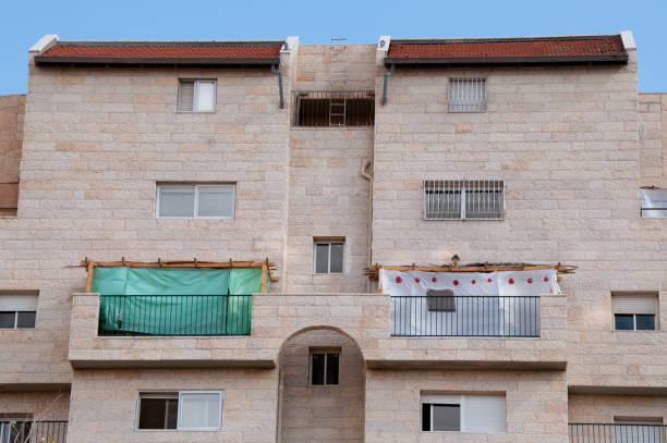 View of a residential building in Israel during Sukkot, in which temporary, wooden structures are placed on balconies as part of the ritual observance of the weeklong Jewish holiday.