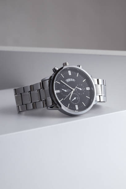 istock Luxury black and silver watch on white table. Monochromatic concept. Complementary color concept 1492328341