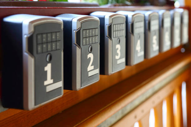 Room keys looked in safes Modern reception with self service. Just type in your password code and get your room key. key package stock pictures, royalty-free photos & images