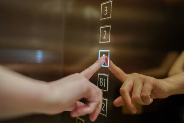 Low Angle View Of Illuminated Arrow Symbol In Elevator