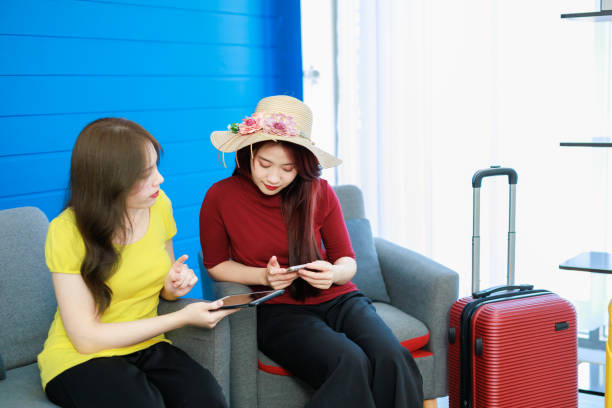 istock Two Female couple enjoying time together on a sofa and using smart phone. 1492332661