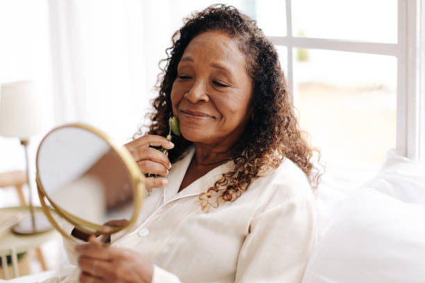 istock Mature woman using a jade roller for her anti-aging skincare routine 1492333124