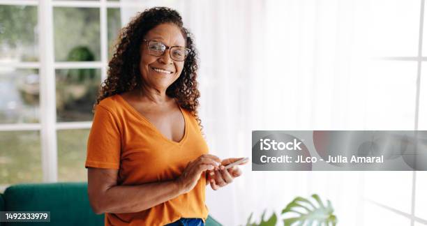 Retire Senior Woman Living Alone Using A Smartphone For Communication Stock Photo - Download Image Now