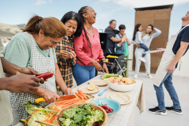 istock Multi generational people doing barbecue at home's rooftop - Multiracial friends having fun eating and cooking together during weekend day - Summer and food concept - Main focus on latin woman face 1492335396